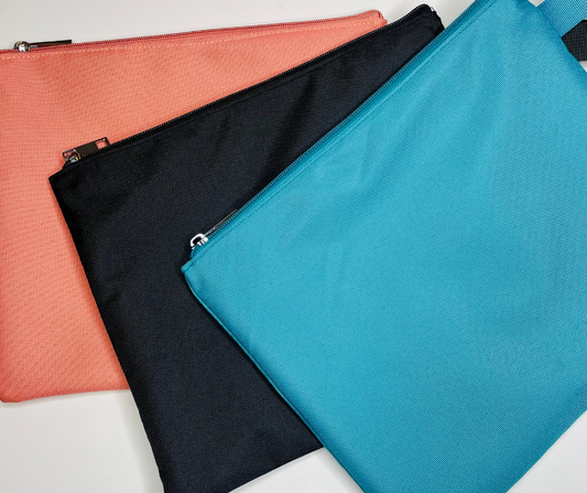 pink, black and blue water resistant bikini bags on a white background