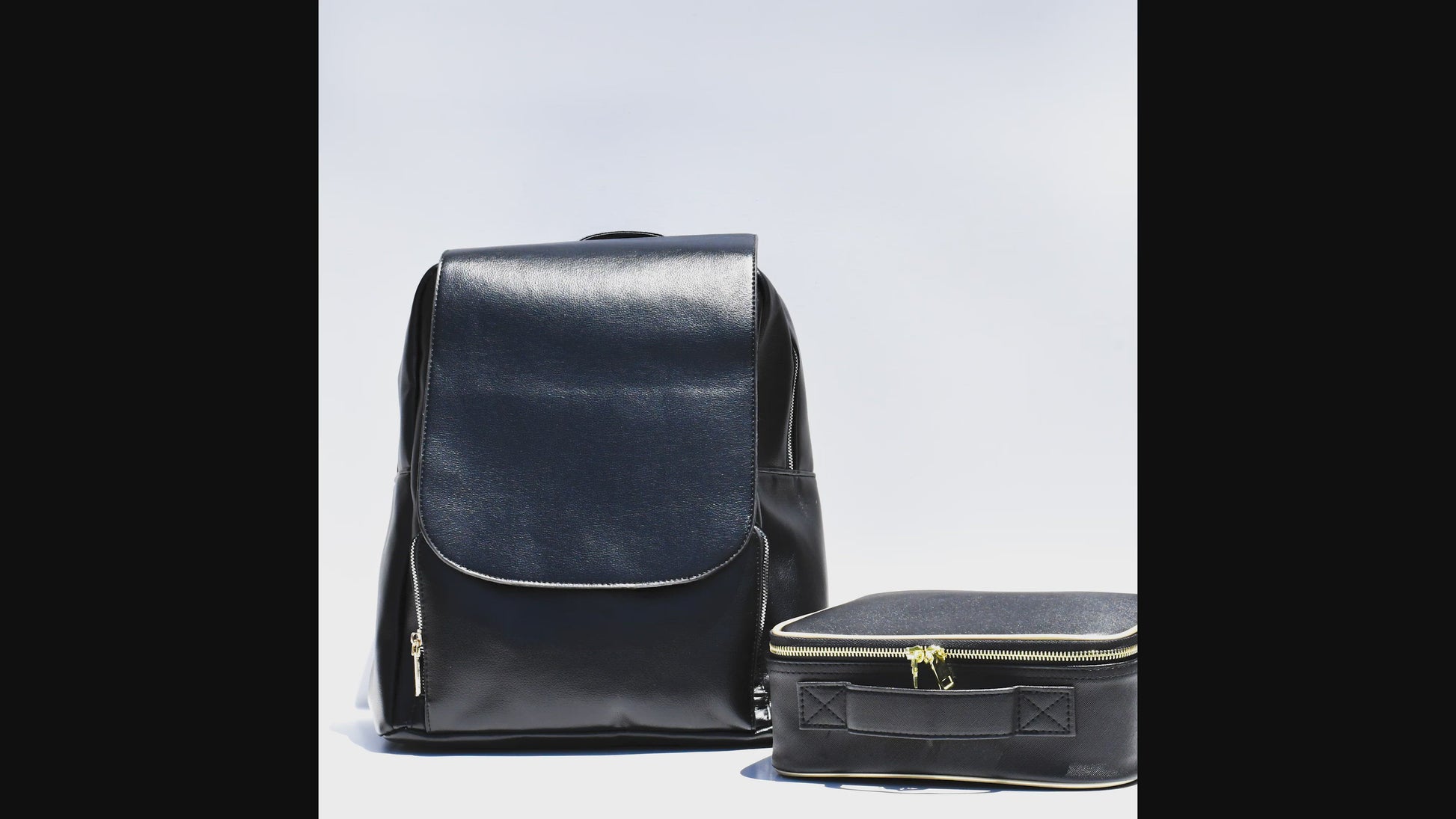 black backpack and cosmetic case on a white background - the video shows items being added to both and showing how much room they both have