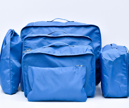 blue packing cubes, packed and on a white background