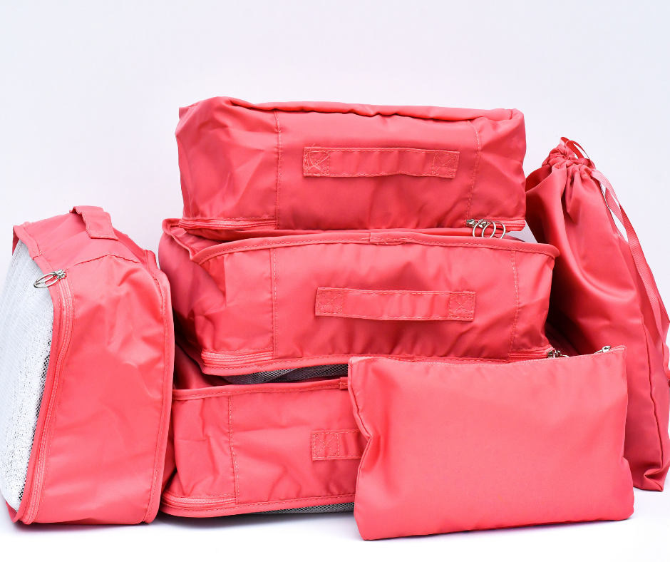 pink packing cubes all packed up and on a white background