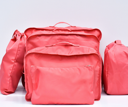 pink packing cubes all packed up and on a white background