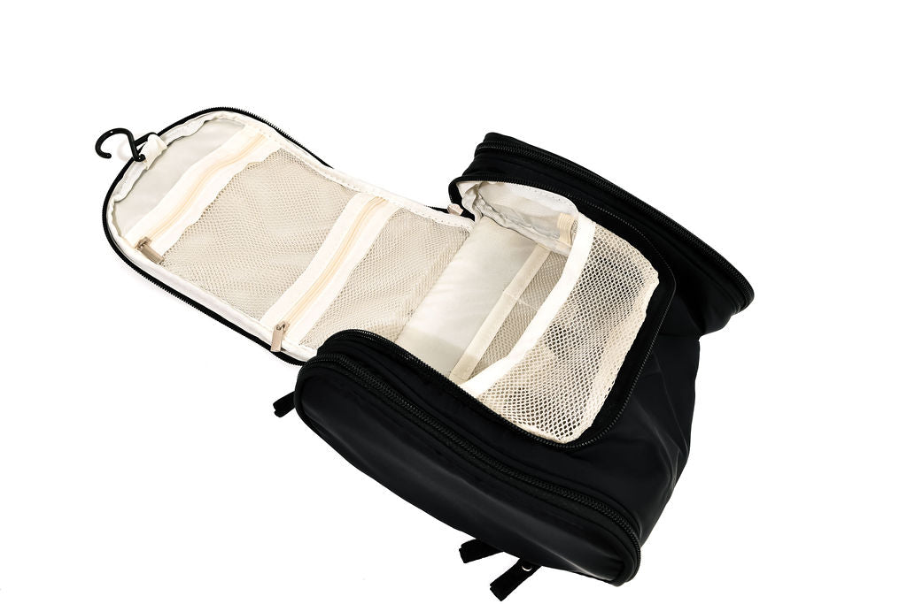 black hanging cosmetic case opened up on a white background