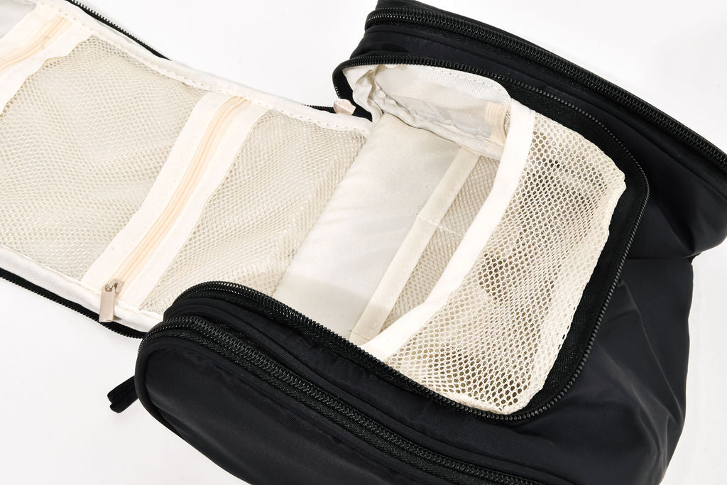 black hanging cosmetic case opened up on a white background
