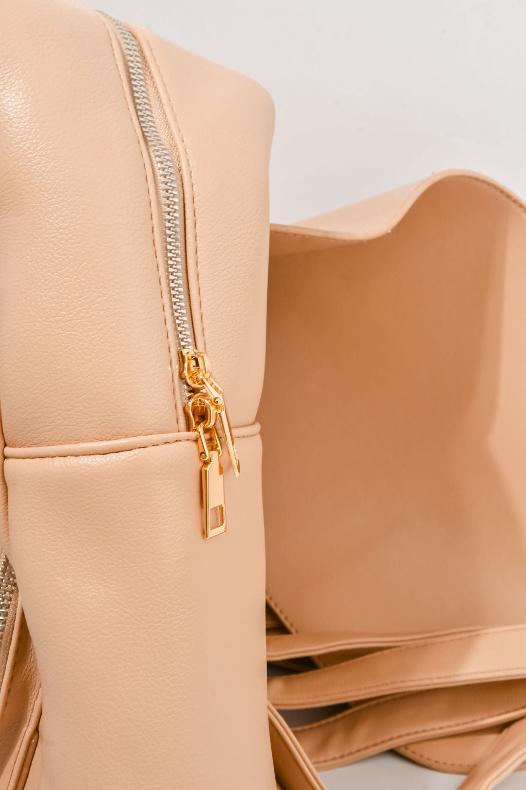 beige backpack on a white background