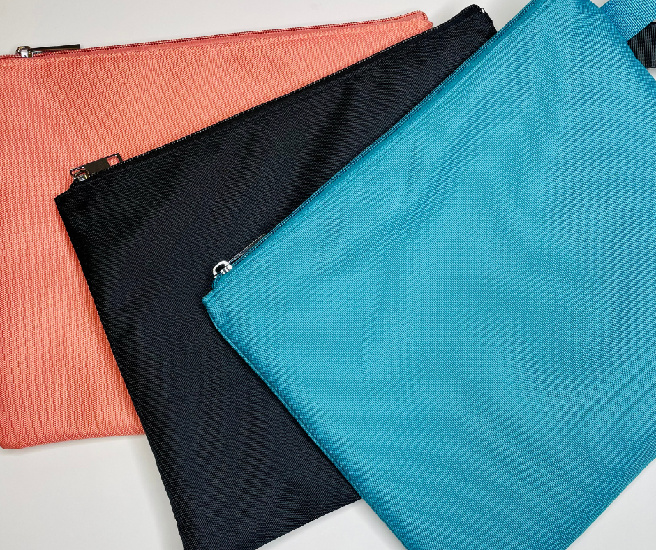 pink, black and blue water resistant bikini bags on a white background