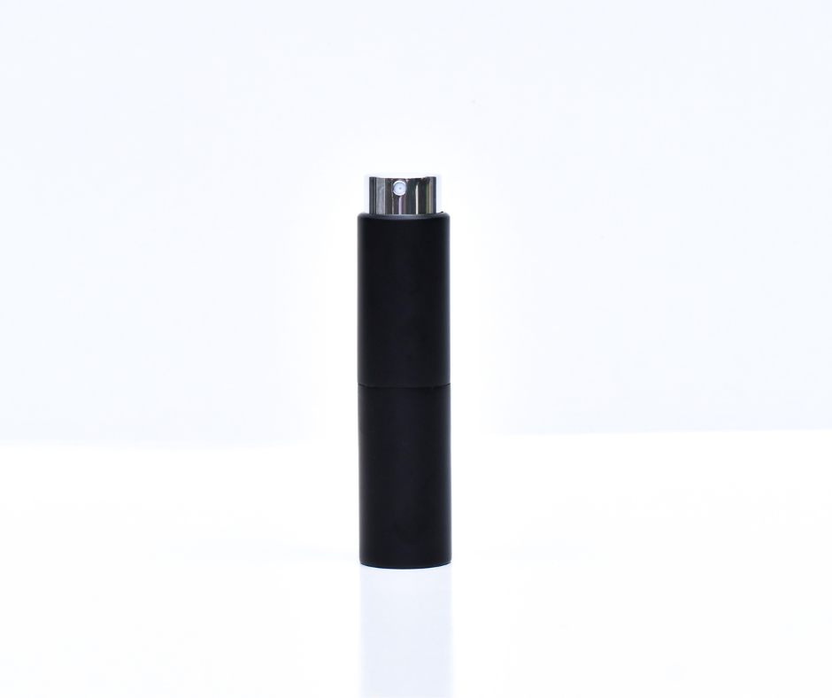black travel (perfume) atomiser on a white background