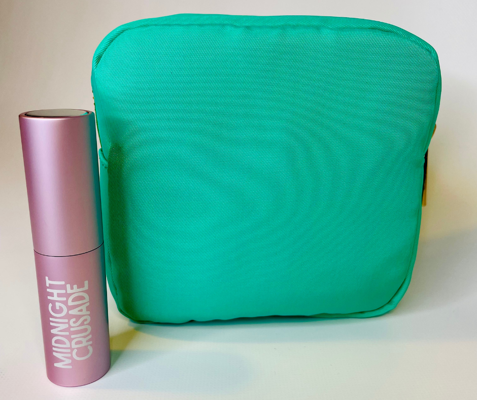 green cosmetic case on a white background with pink travel atomiser sitting next to it