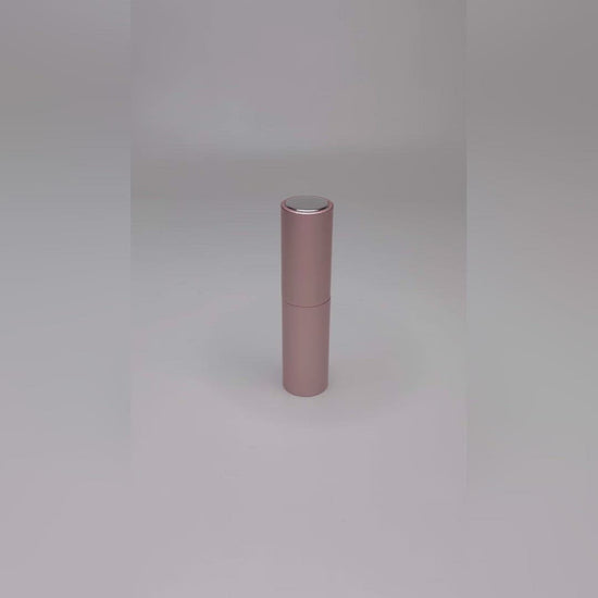 video showing the pink travel atomiser being pulled apart, filled and sprayed