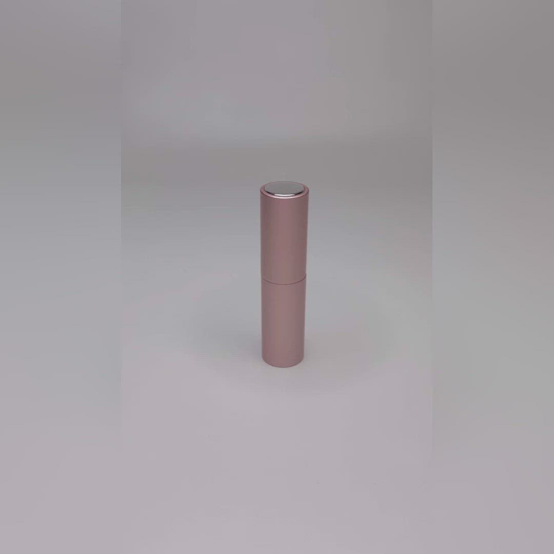video showing the pink travel atomiser being pulled apart, filled and sprayed