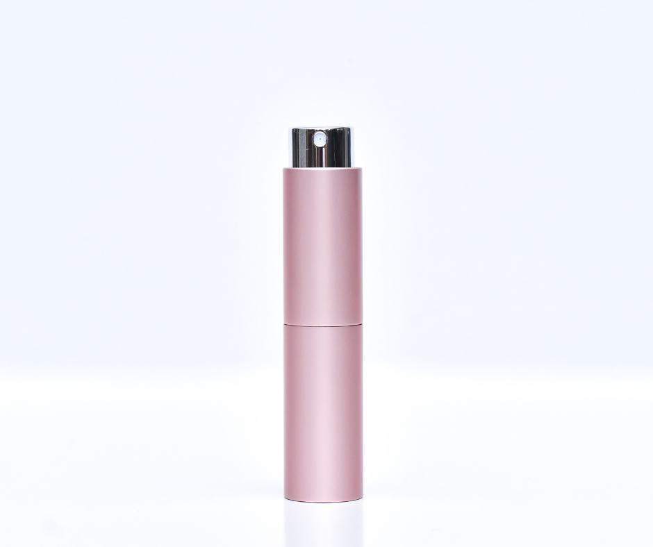 pink travel atomiser (perfume atomiser) on a white background