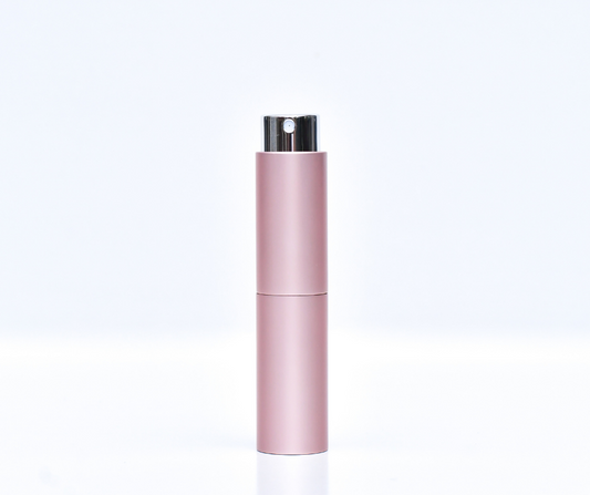pink travel atomiser (perfume atomiser) on a white background