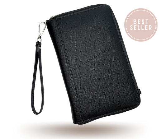 black passport wallet/bag with wrist strap attached on a white background