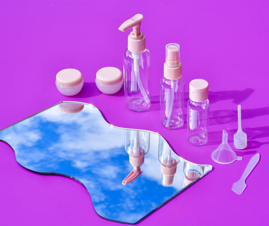 8 piece travel bottle set on a purple background looking into a cloudy mirror reflection
