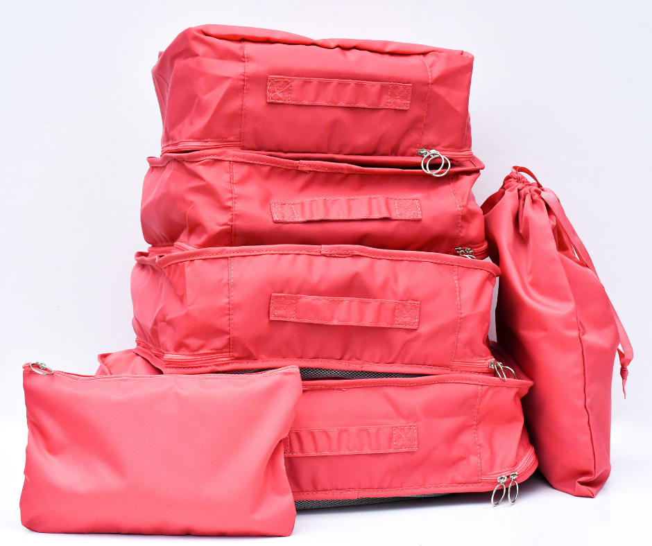 pink packing cubes all packed up and on a white background