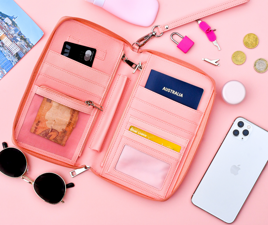 pink travel bag on a pink background with contents spilled out showing the size