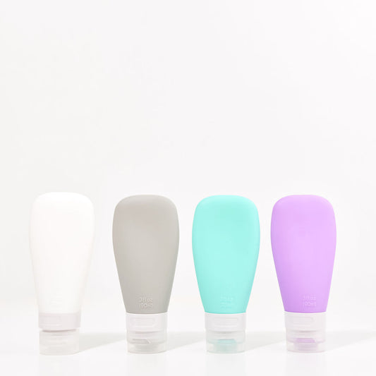 90ml travel bottles (purple, grey, white and green) on a white background