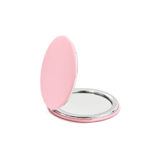 pink compact mirror on a white background