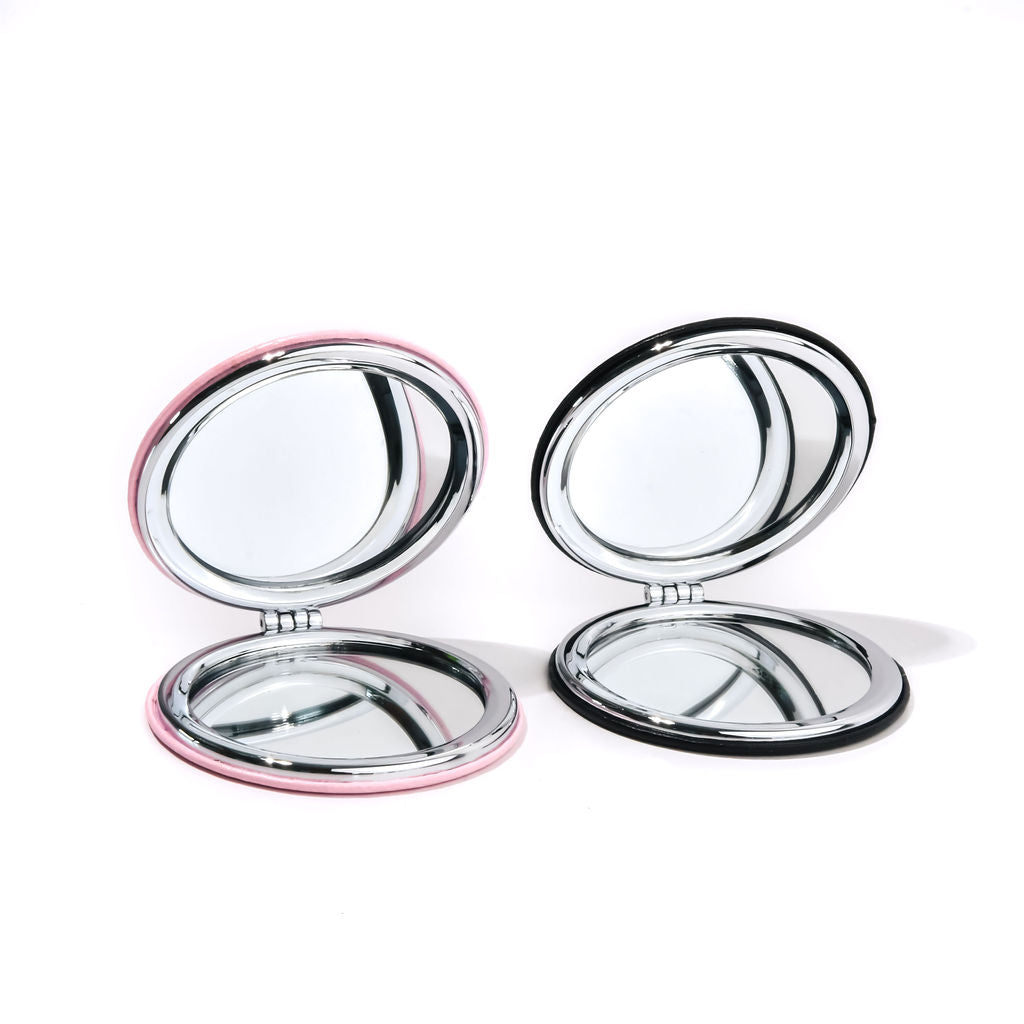 black and pink compact mirrors on a white background
